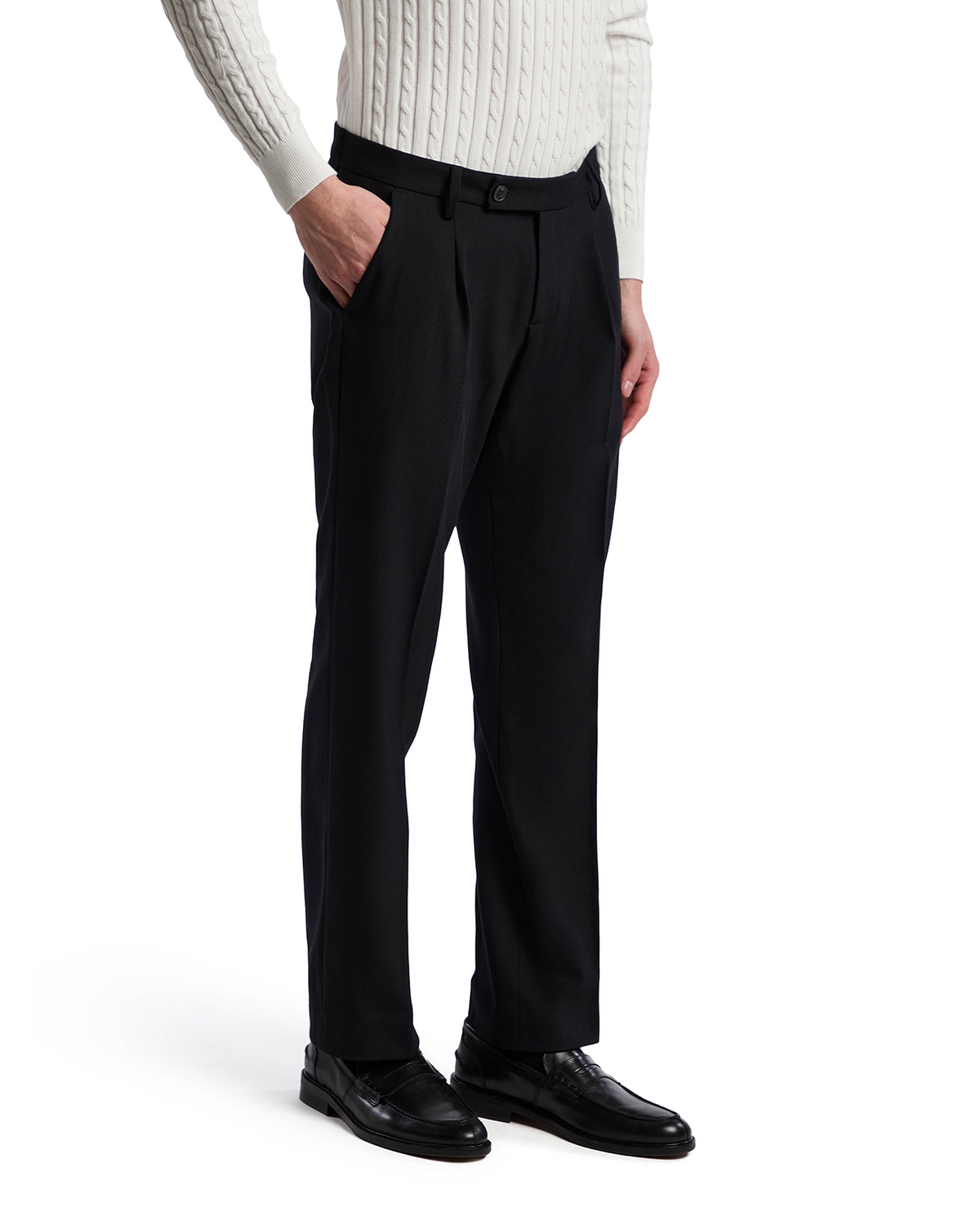 Men's black tailored trousers in lightweight fabric, featuring a pleated front and side pockets, paired with a white sweater.