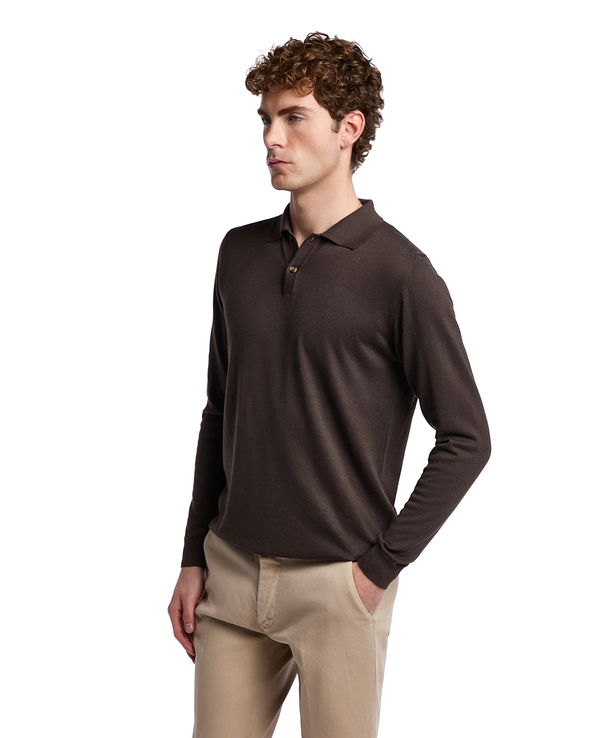 Men's brown long-sleeve polo shirt in soft fabric, featuring a classic collar and three-button placket, styled with beige trousers.