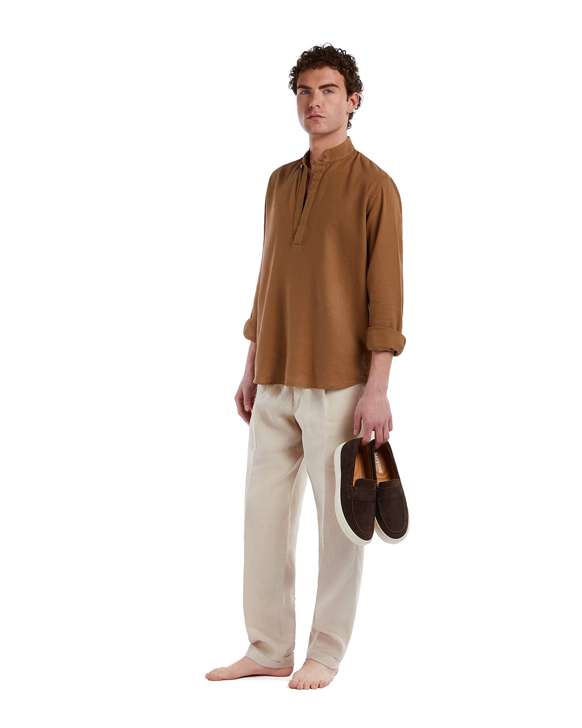 Brown linen shirt paired with light beige linen trousers and stylish brown slip-on shoes, perfect for casual wear.