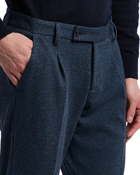 Men's navy checkered dress trousers, crafted in blended fabric with pleated front and classic button closure.