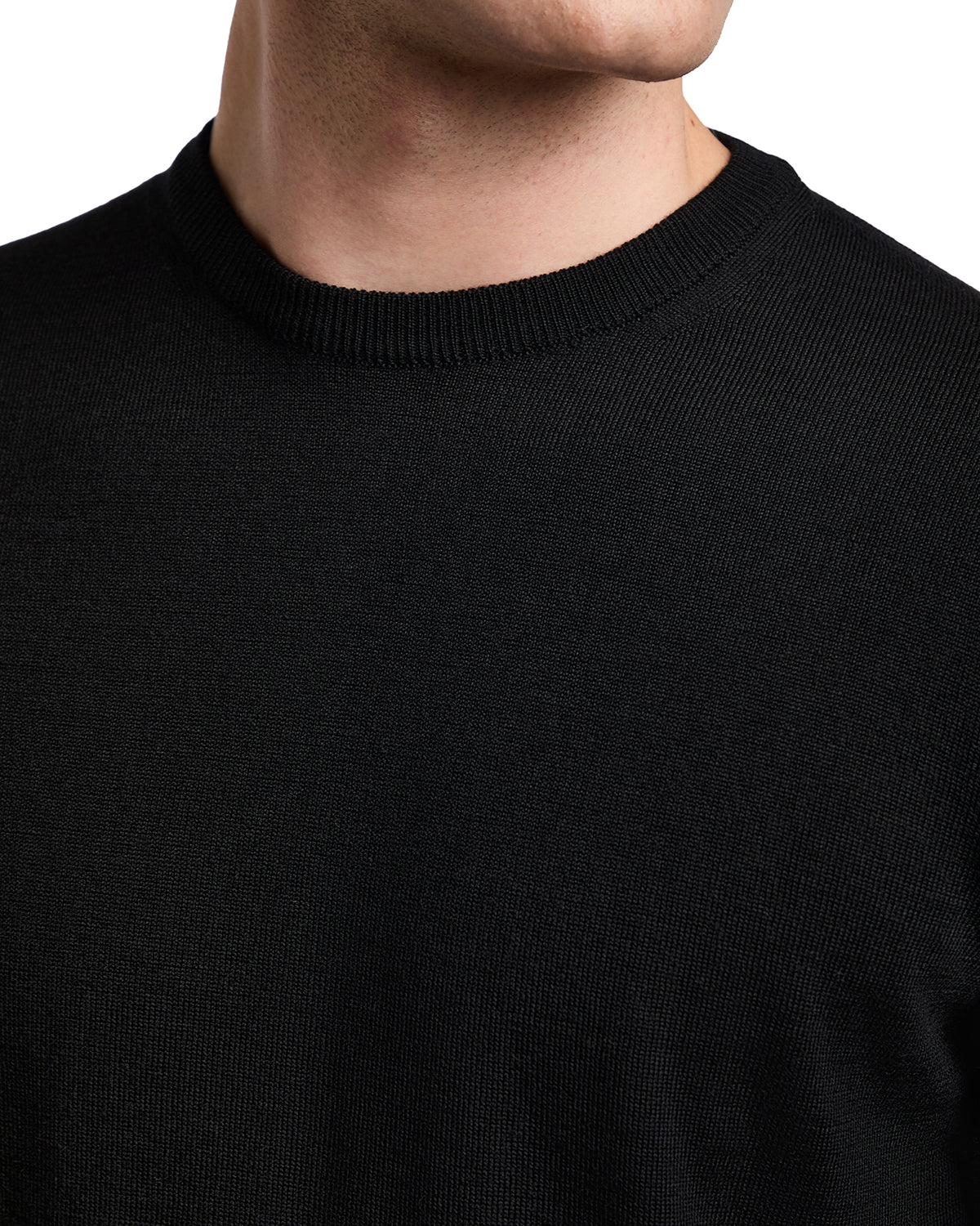 Men's black crew neck sweater made of soft knit material, perfect for casual and formal occasions.