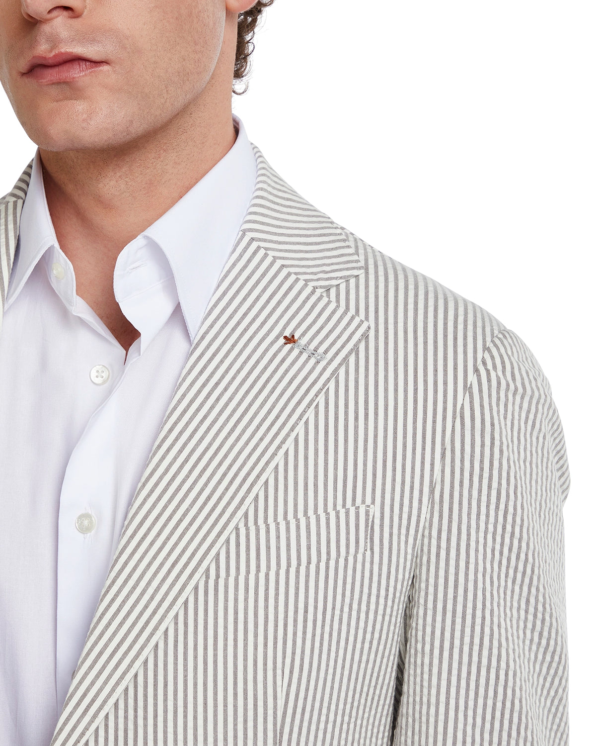 Men's striped blazer in beige and white cotton, featuring a notch lapel and subtle logo detail on the lapel.
