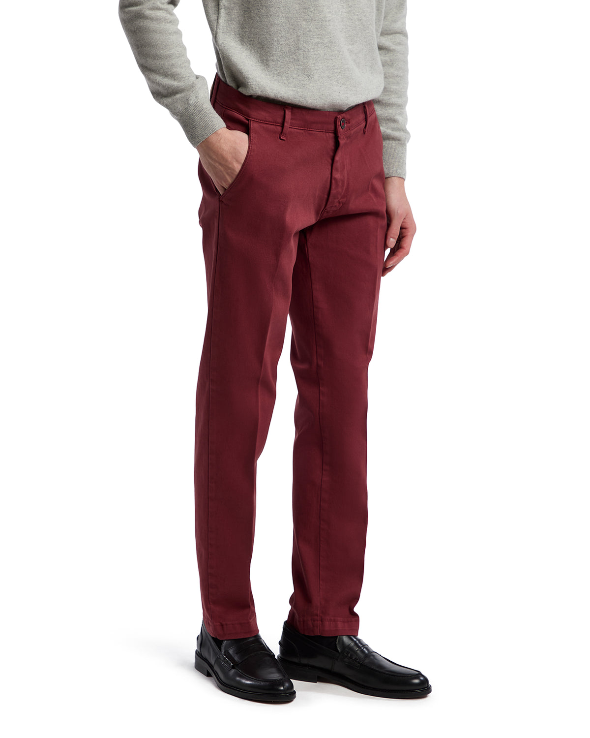Men's burgundy cotton chinos with a modern fit, paired with a light grey sweater and black dress shoes.