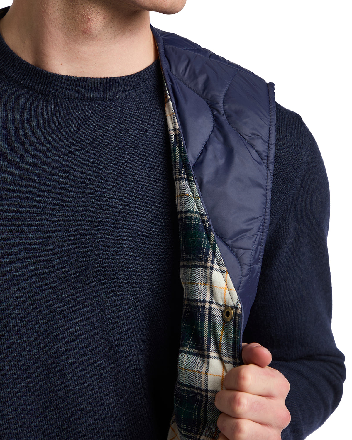 Navy quilted vest with plaid lining, stylish men's layering piece perfect for cool weather.