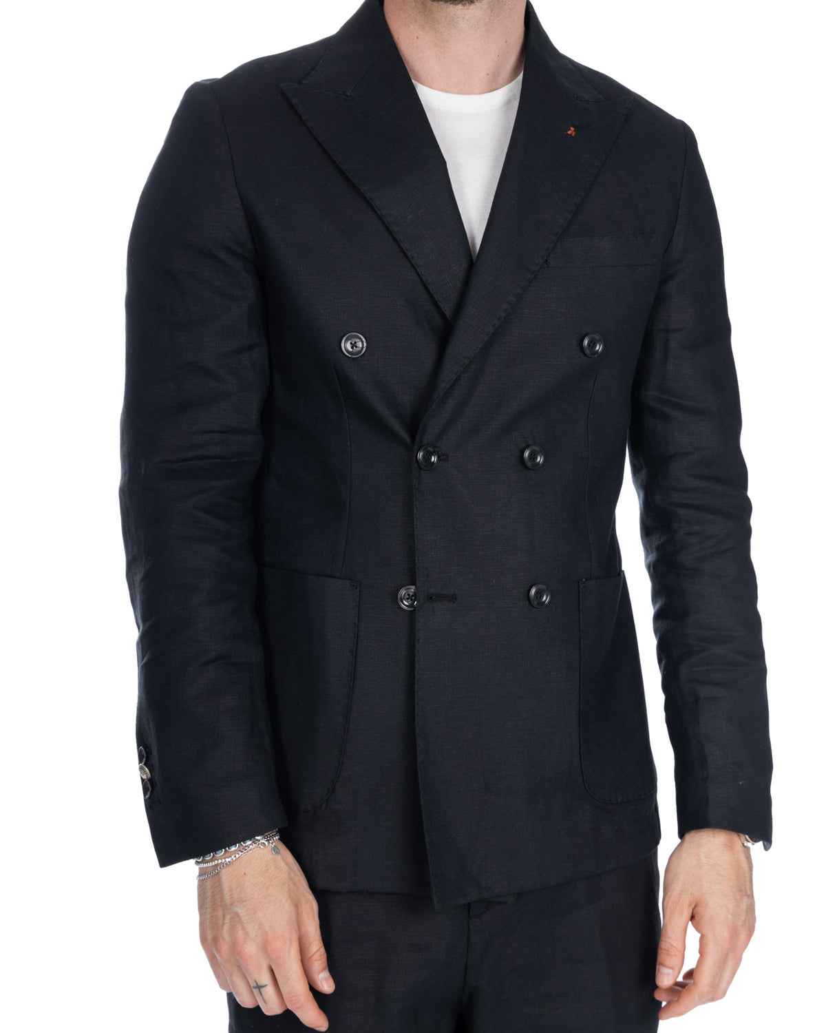 Black linen double-breasted blazer with notched lapels, patch pockets, and horn buttons. Unstructured tailored fit.