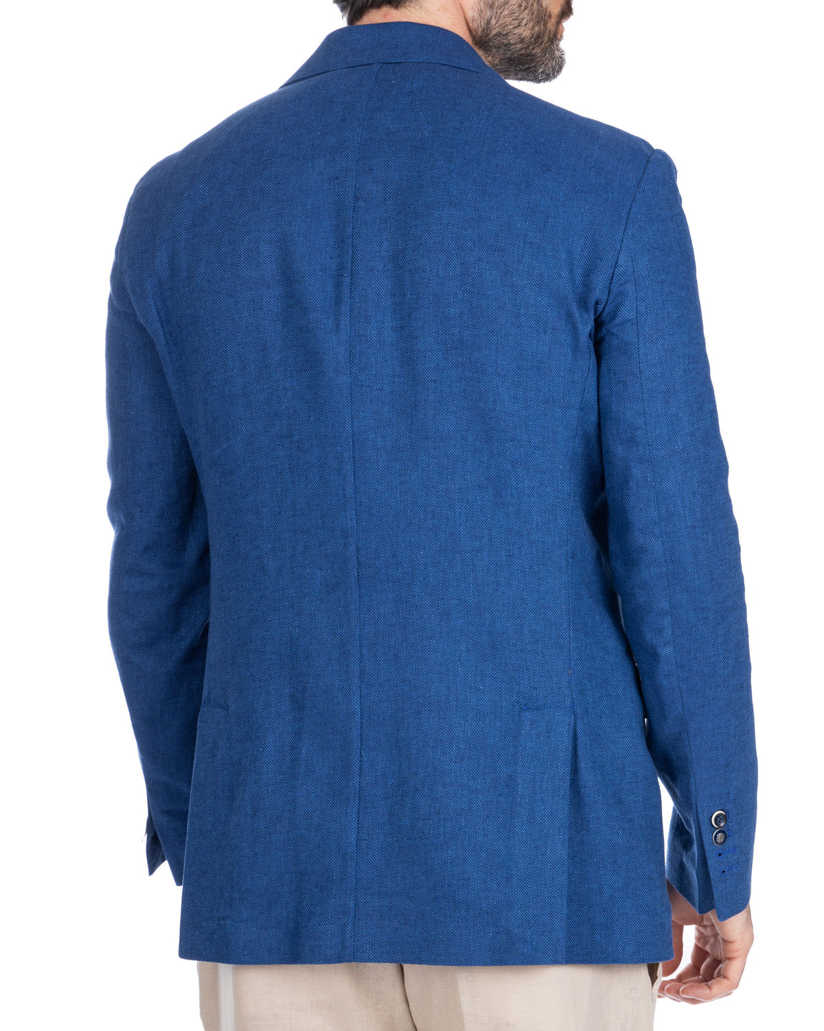 Blue herringbone wool blazer, back view. Tailored fit with button cuffs. Men's formal jacket in royal blue texture.