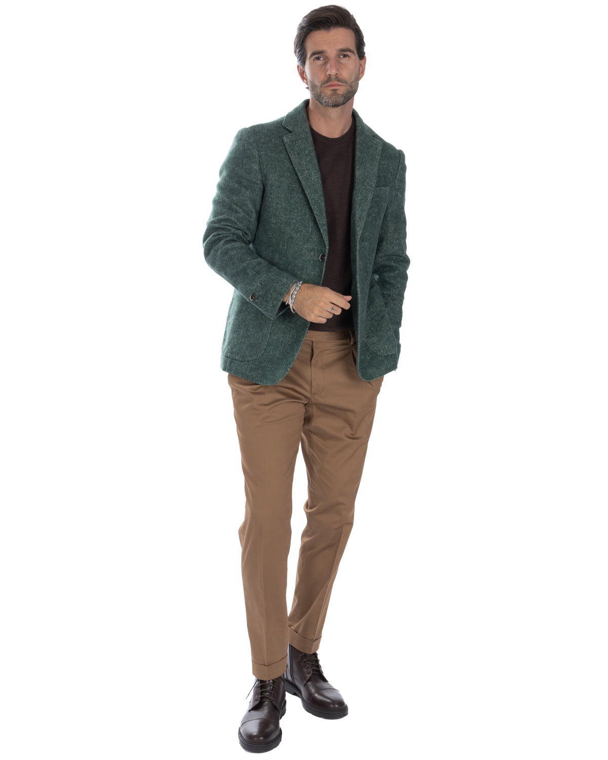 Green wool blazer with brown sweater, tan chinos, and dark brown leather boots. Smart casual men's fashion.