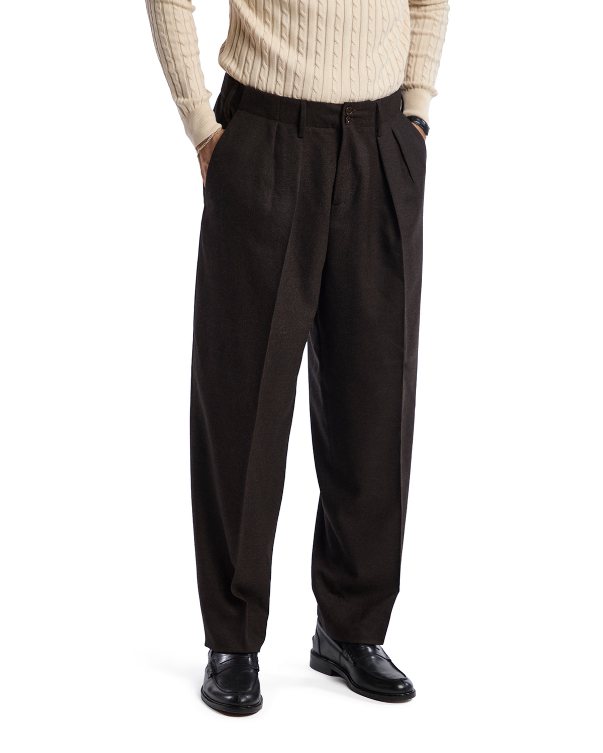 Brown wool pleated trousers for men, tailored fit, stylishly paired with a cream cable-knit sweater.