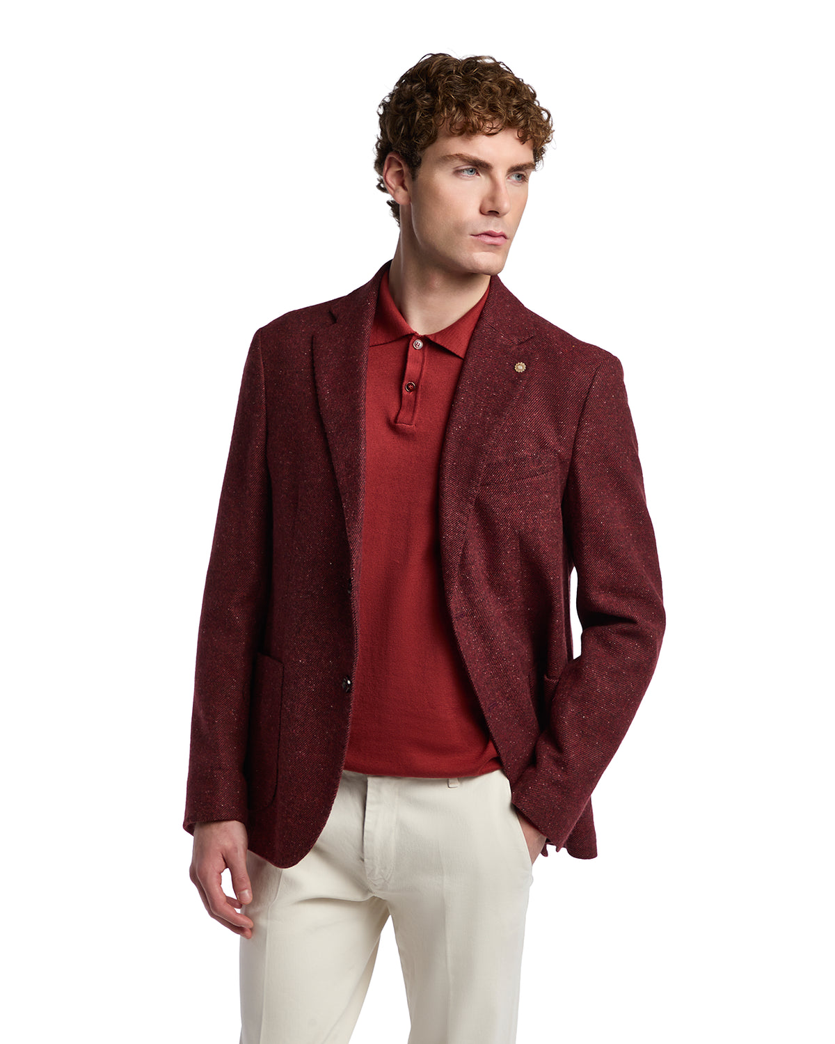 Men's burgundy blazer in textured wool, paired with a casual red polo and cream trousers for a sophisticated look.