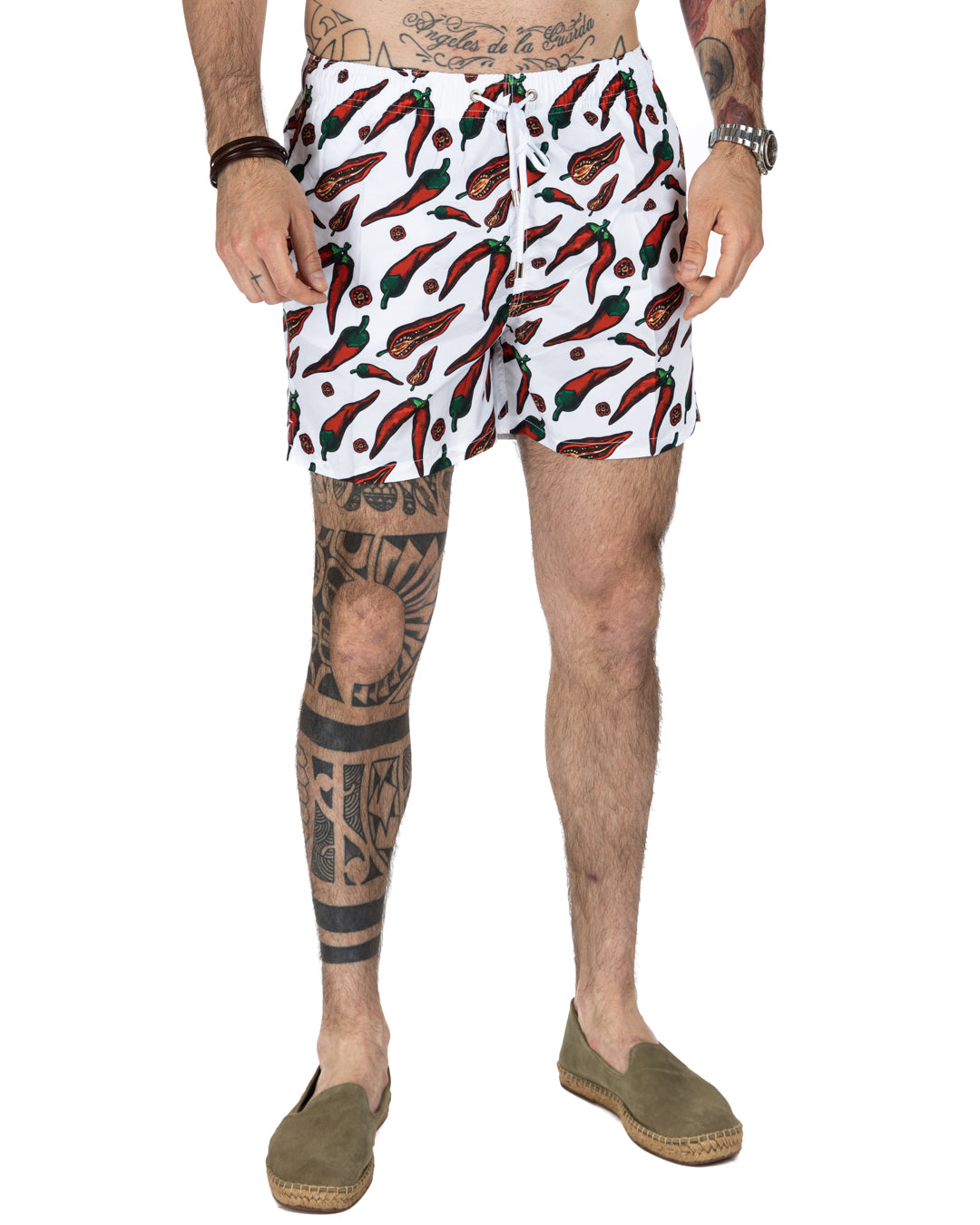 White chili pepper print men's swim trunks with drawstring waist, quick-dry fabric, and mesh lining.