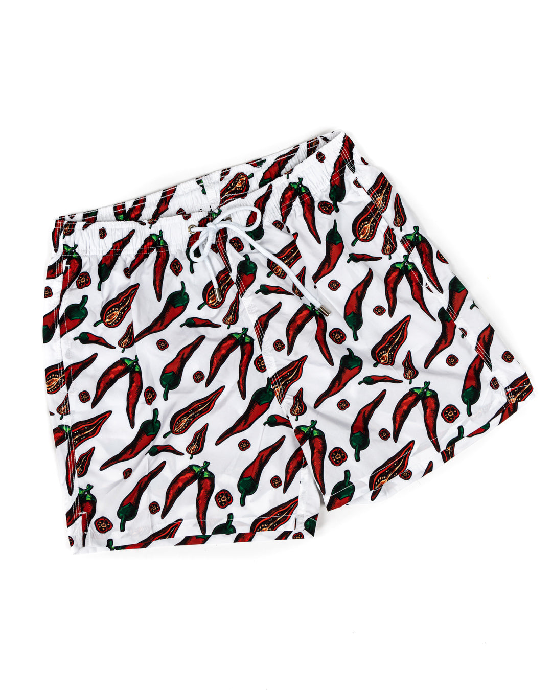 White swim trunks with red chili pepper print, drawstring waist, quick-dry fabric. Men's beach shorts.