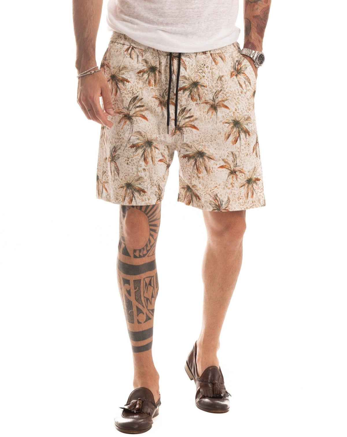 Beige palm tree print shorts with elastic waist, shown from the back