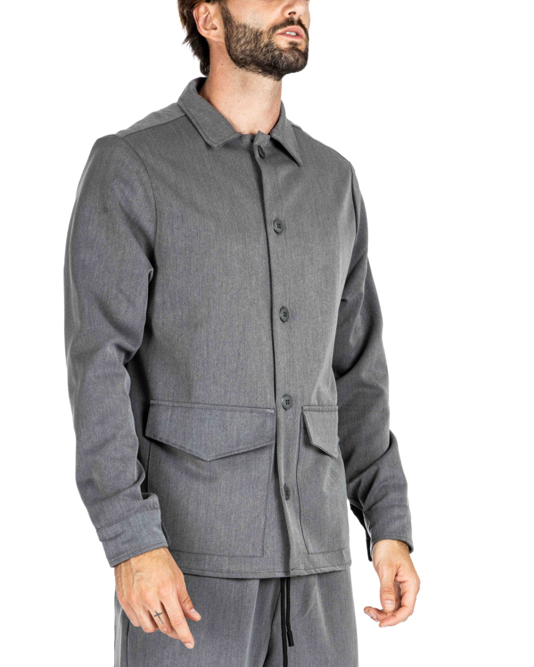 Men's gray button-up overshirt with flap pockets and drawstring pants, shown on a model