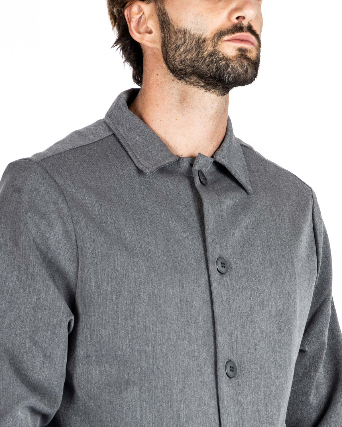 Close-up of a gray overshirt collar and button placket, shown on a model