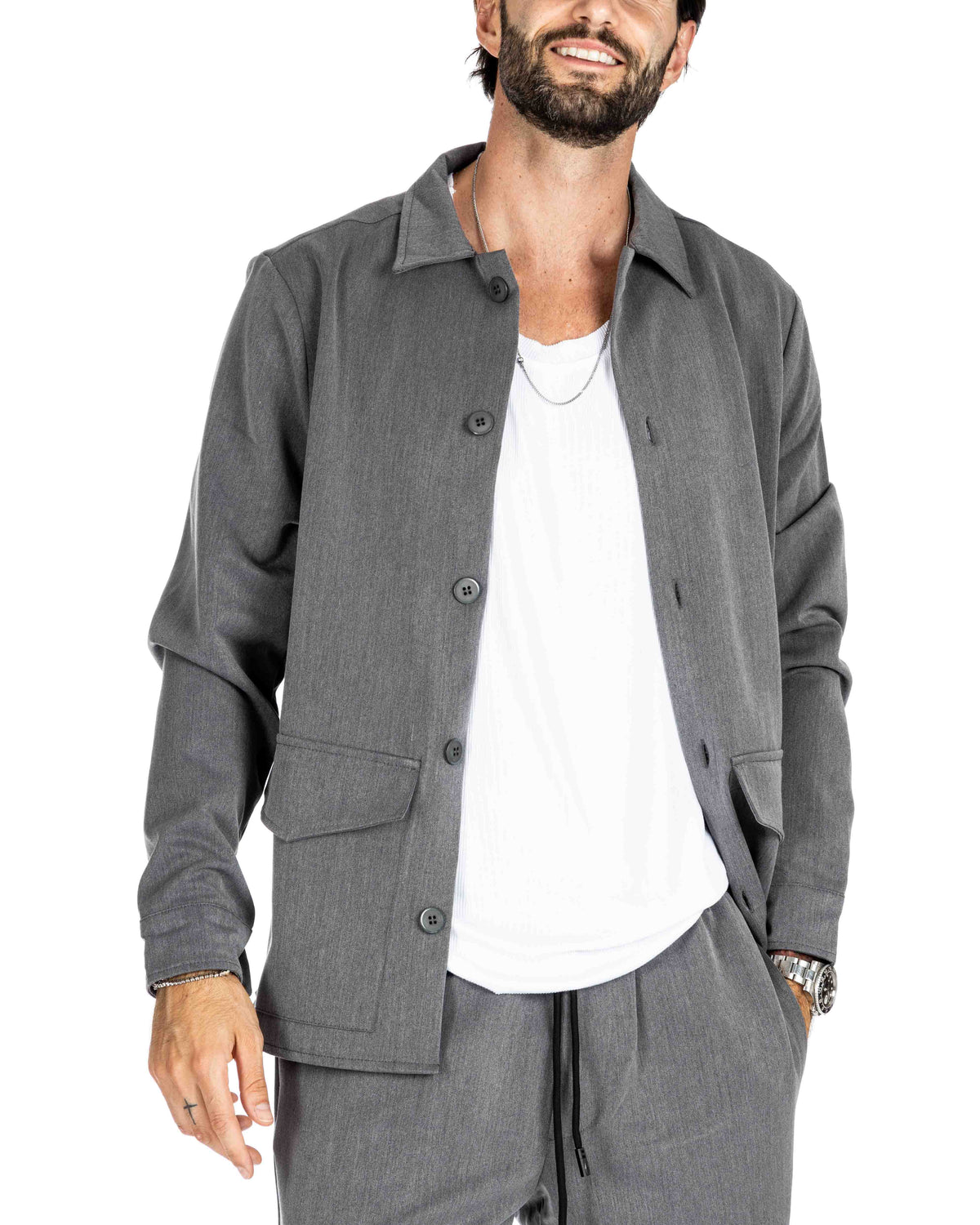 Men's gray overshirt jacket with button front and chest pockets over a white tank top, shown on a model
