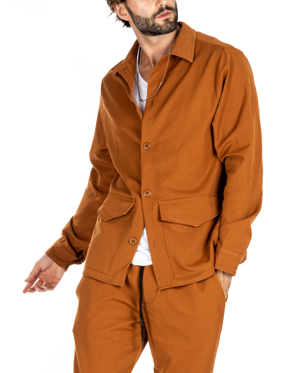 Men's rust orange knit overshirt with flap pockets, worn with matching drawstring pants, shown on a model