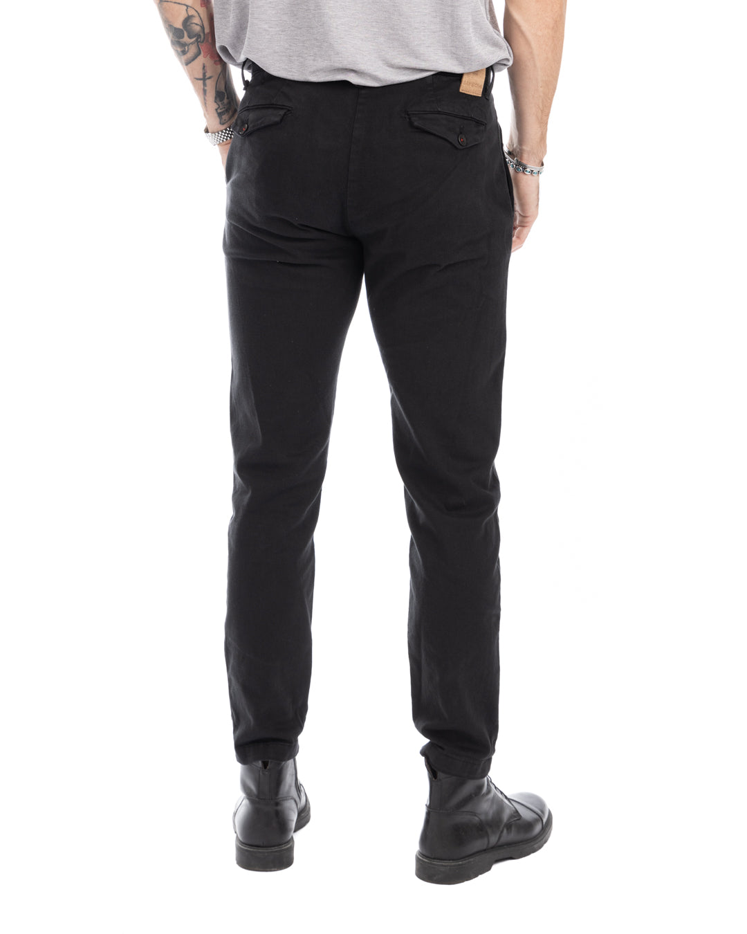 Men's black slim-fit cotton chinos with buttoned back pockets, shown from the back view.