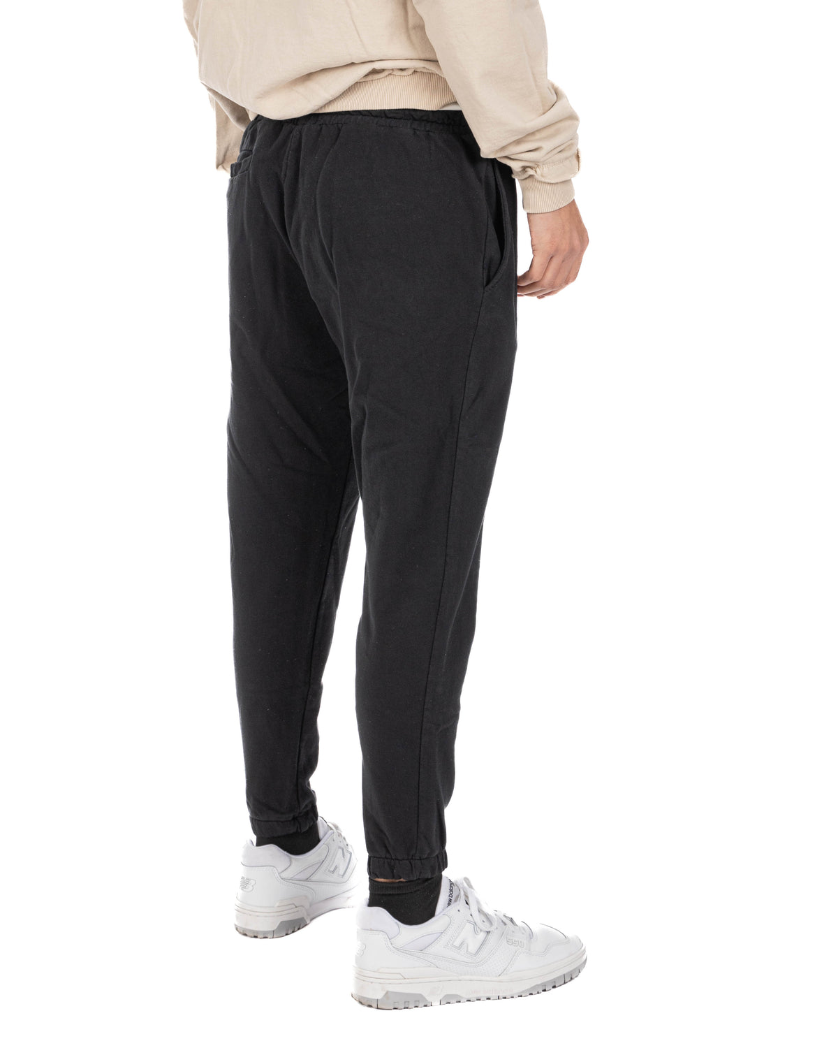 Black cotton joggers with elastic waist and cuffs, side pockets, relaxed fit, casual loungewear style