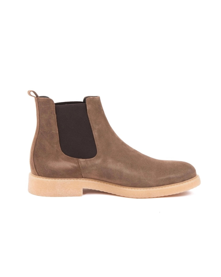 Taupe suede Chelsea boot with black elastic side panels and cream crepe sole, shown in side profile
