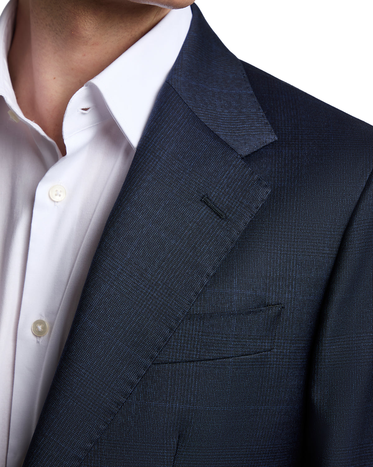 Navy blue textured men's blazer with notched lapels, paired with a crisp white dress shirt.