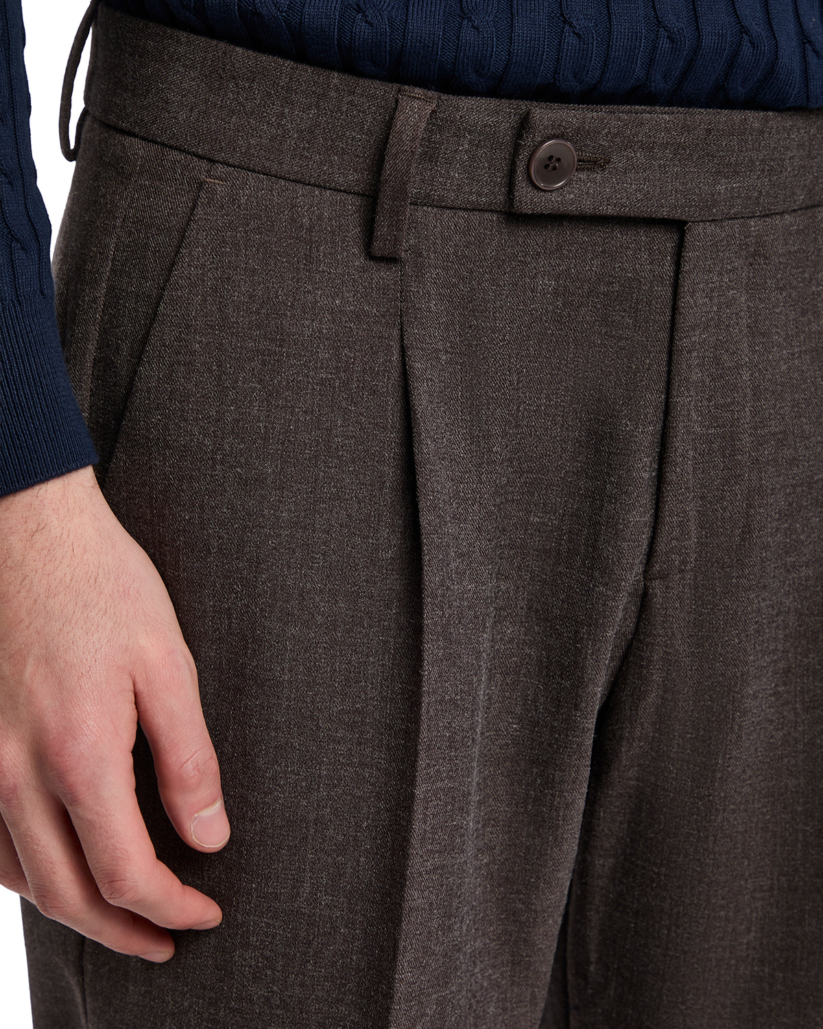 Men's brown pleated trousers made from lightweight fabric, featuring a stylish button detail and a tailored fit.
