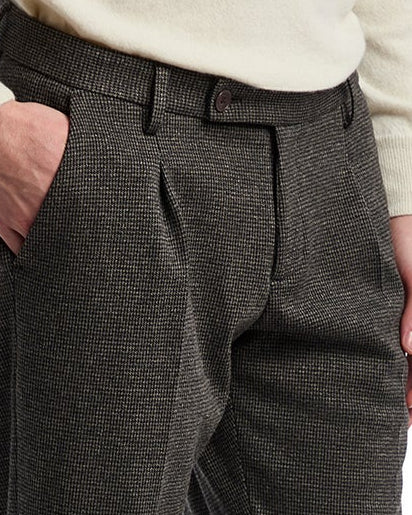 Men's tailored gray plaid trousers with pleats, crafted from a textured wool blend for a stylish look.