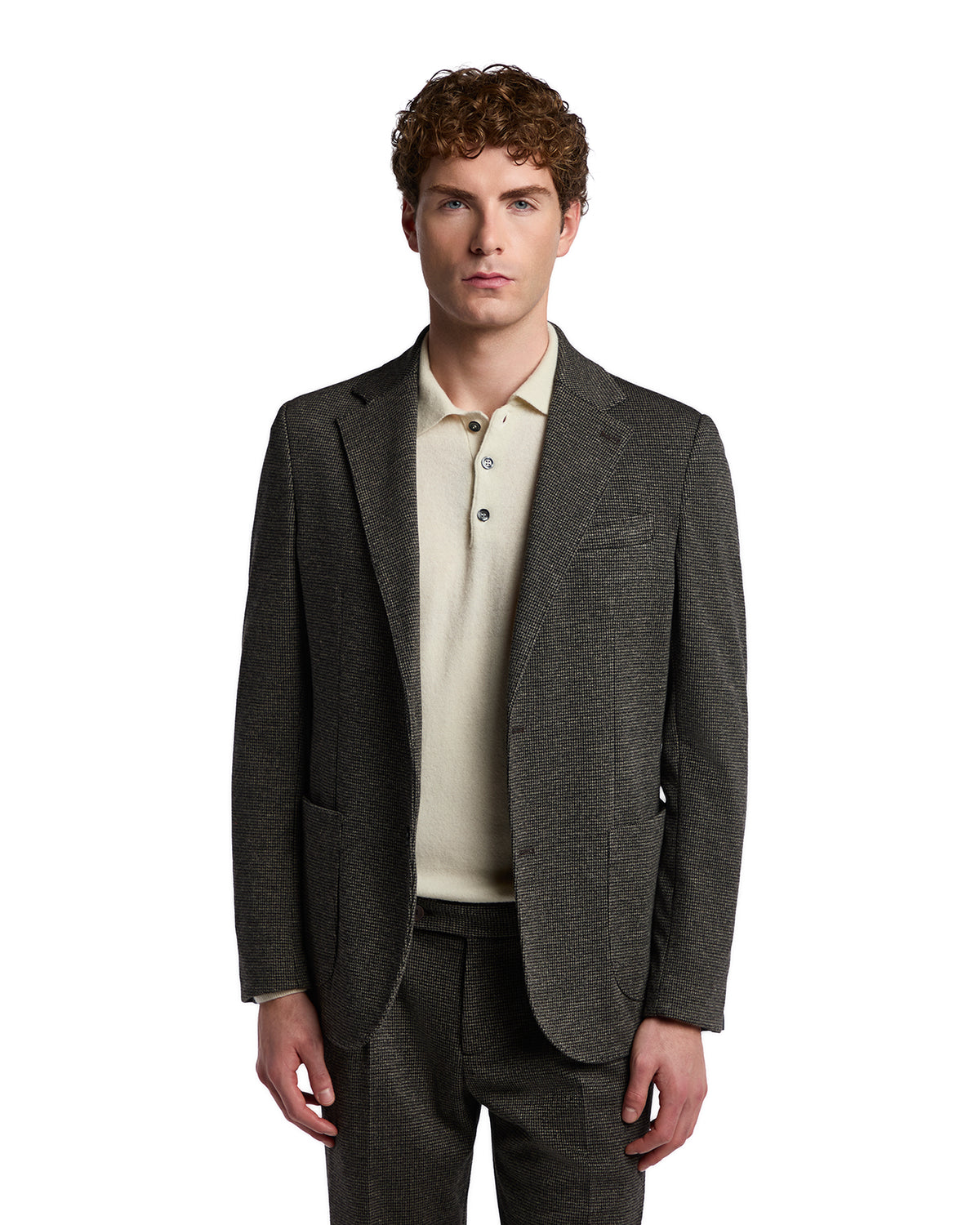 Men's gray wool blazer with subtle texture, styled with a cream polo shirt for a sophisticated look.