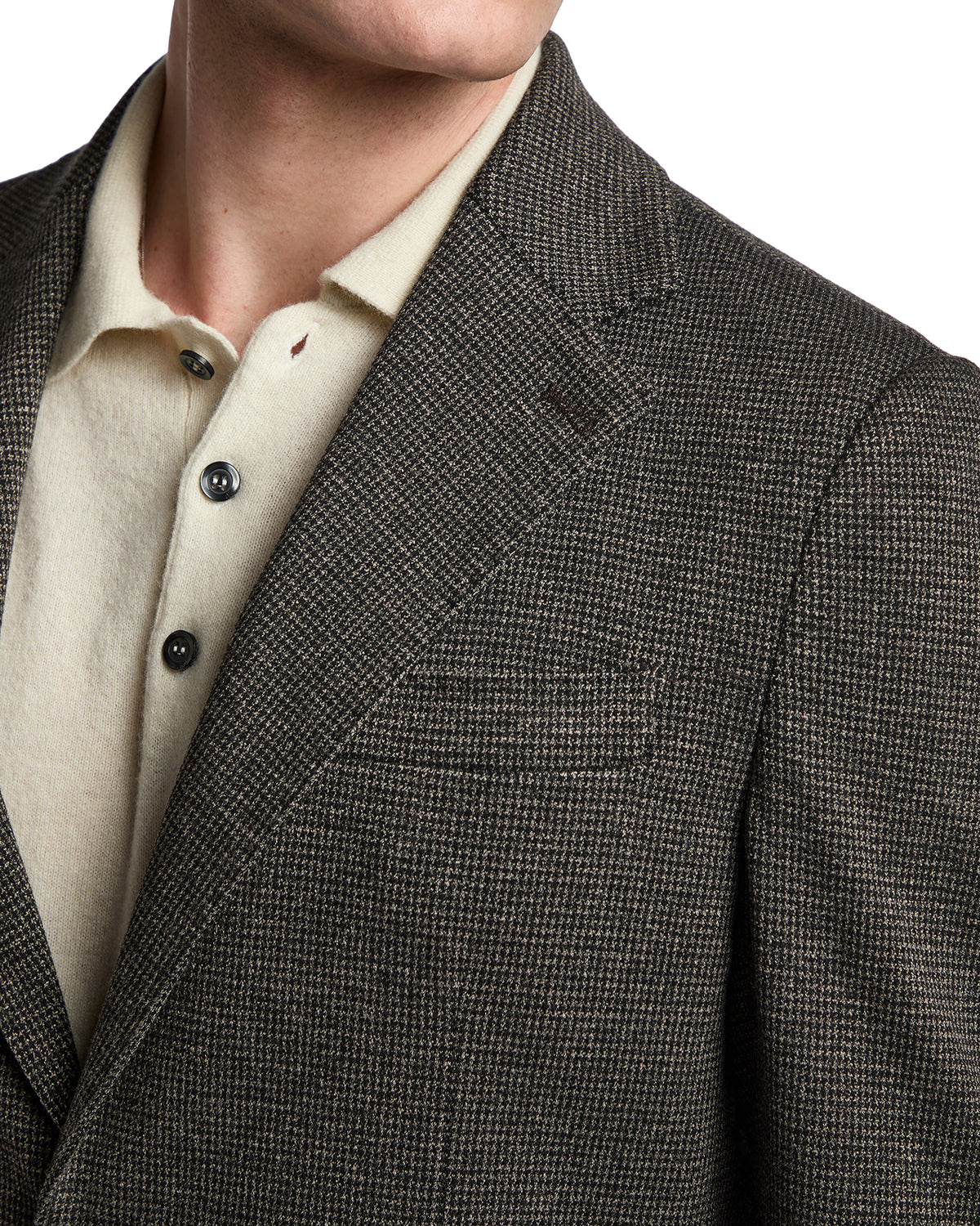 Brown houndstooth wool blazer with notch lapels, paired with a cream knit polo shirt. Stylish and sophisticated.