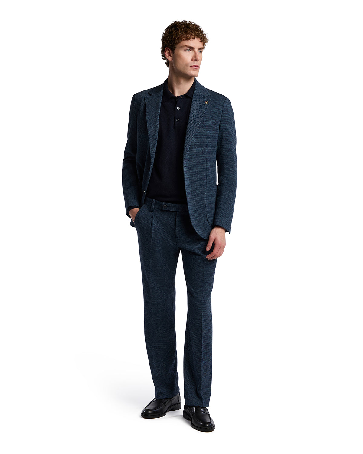 Men's tailored navy blue wool suit with textured finish, paired with a black polo, perfect for formal occasions.
