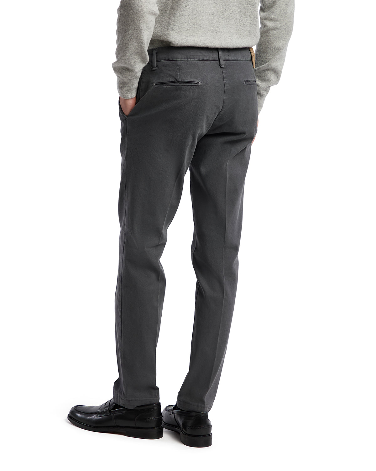 Men's gray chinos in lightweight cotton, featuring a slim fit and stylish back pockets, paired with black dress shoes.
