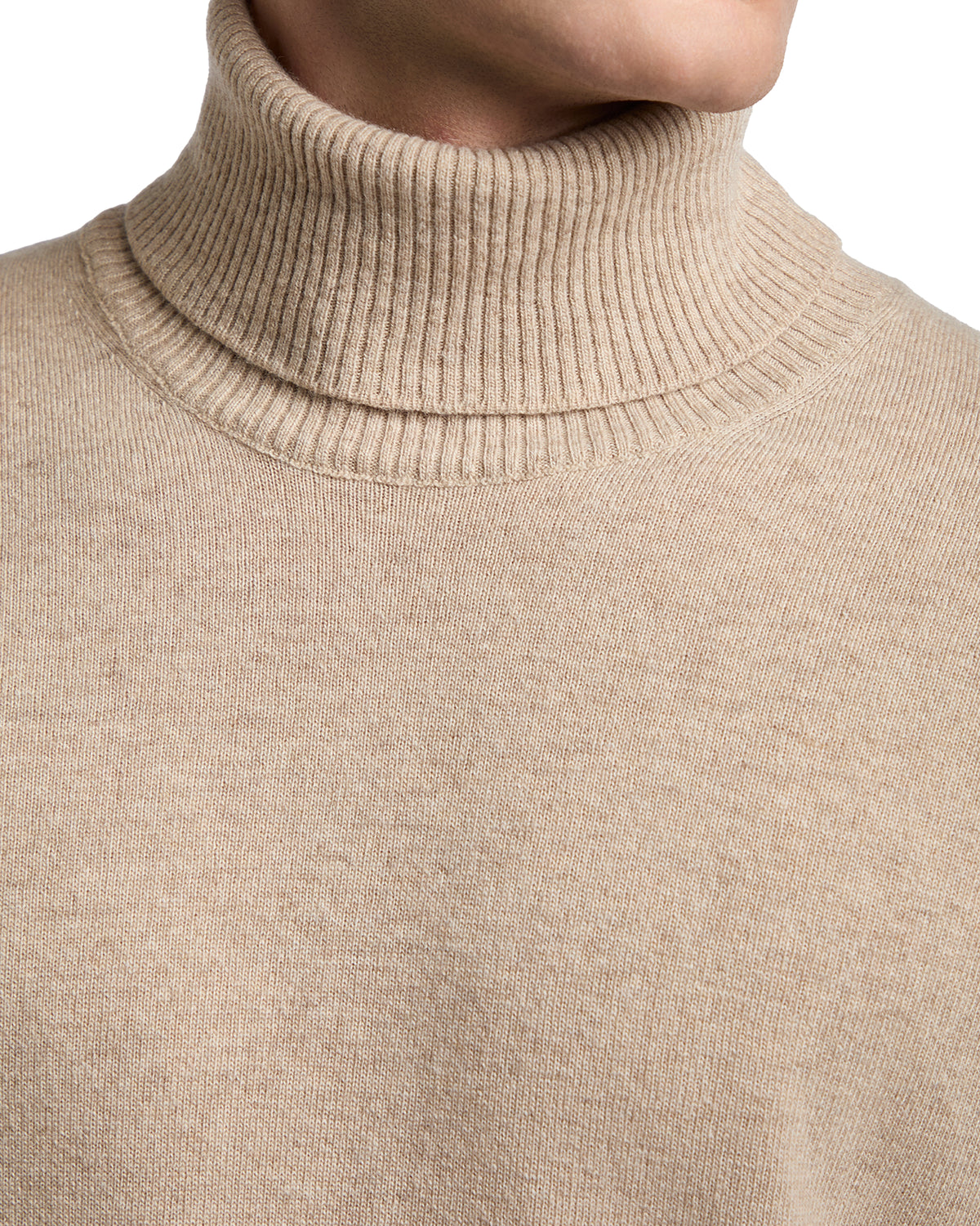 Beige turtleneck sweater made of soft knit fabric, featuring a ribbed high collar for a stylish look.