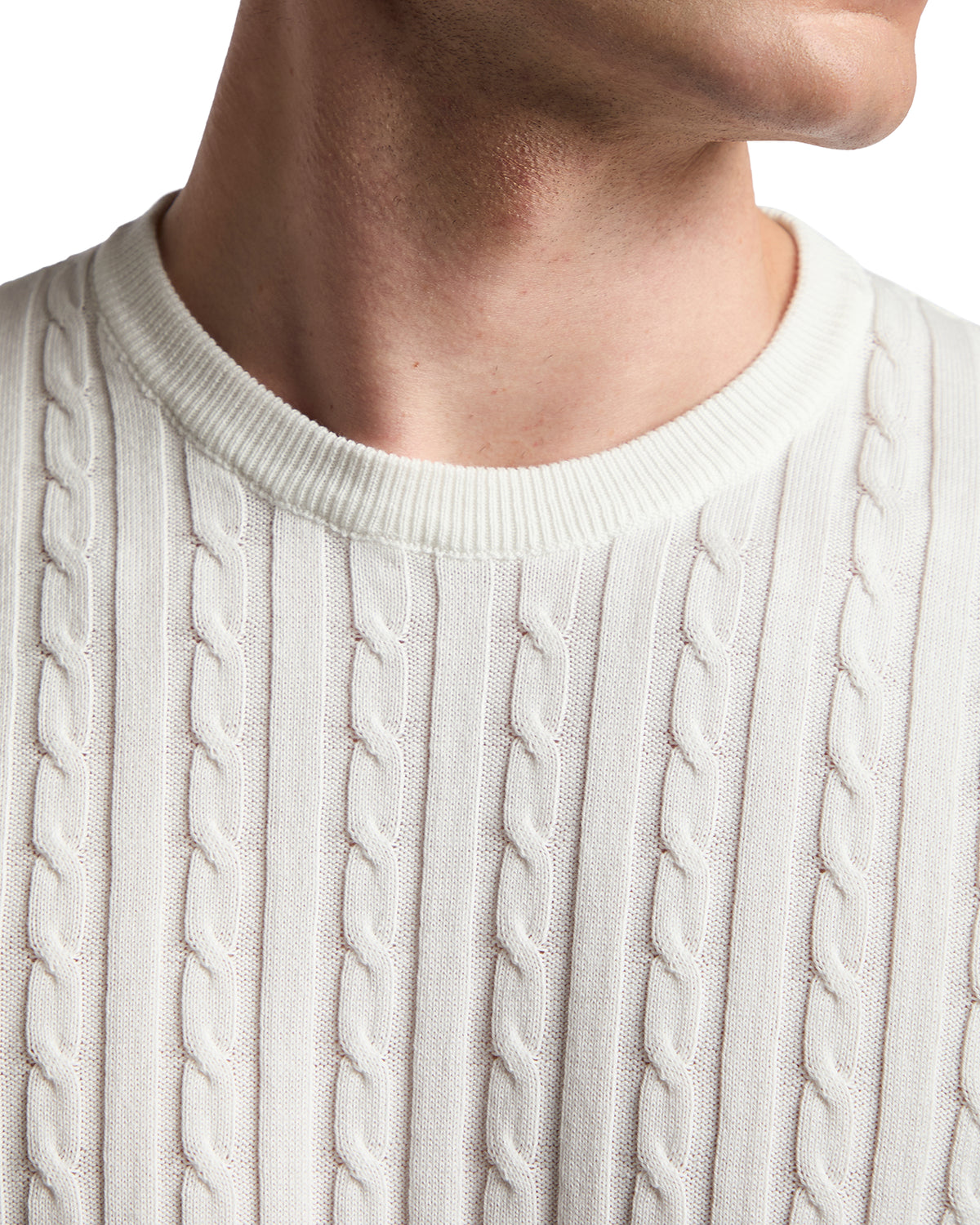 Men's cream cable-knit sweater made from soft cotton, featuring a classic crew neckline and textured design.