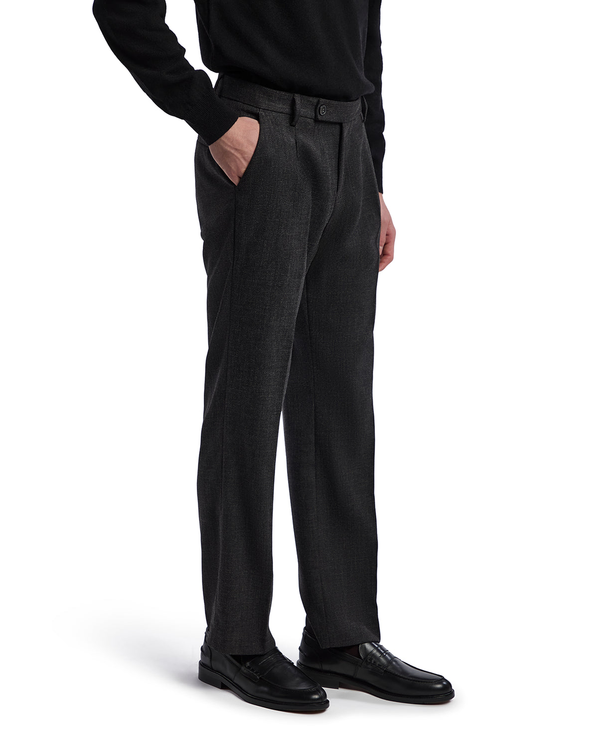 Men's charcoal grey wool dress pants with a tailored fit and side pockets, paired with black leather shoes.