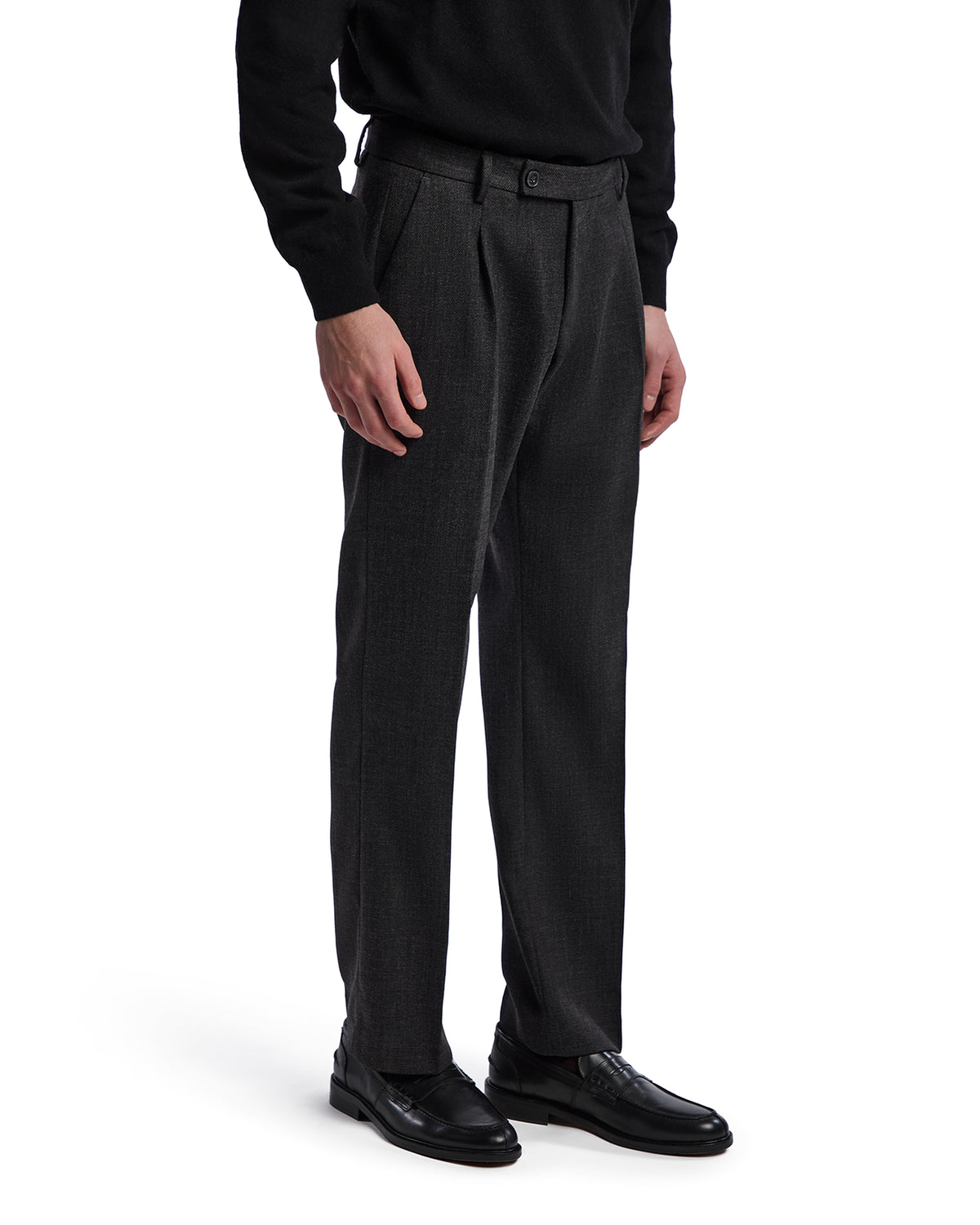 Men's gray wool blend dress pants with a tailored fit and front pleats, paired with black leather shoes.