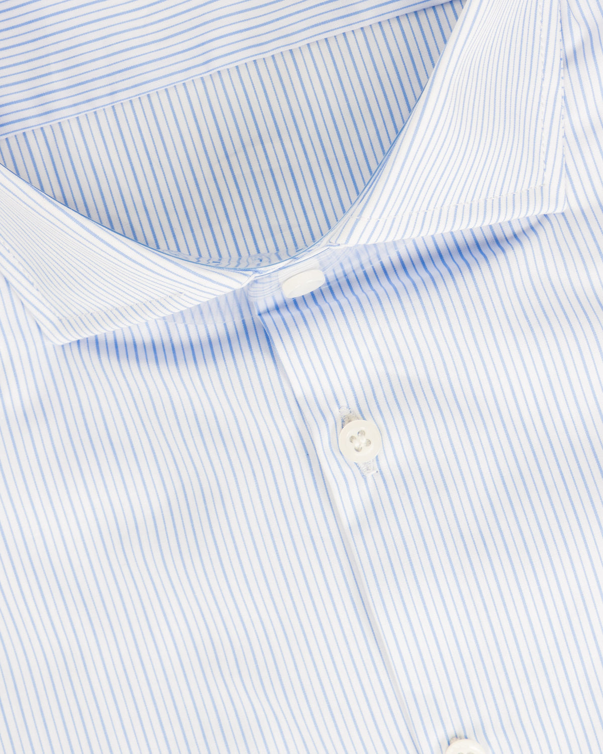 Blue and white striped cotton dress shirt with button-down collar, close-up detail view.