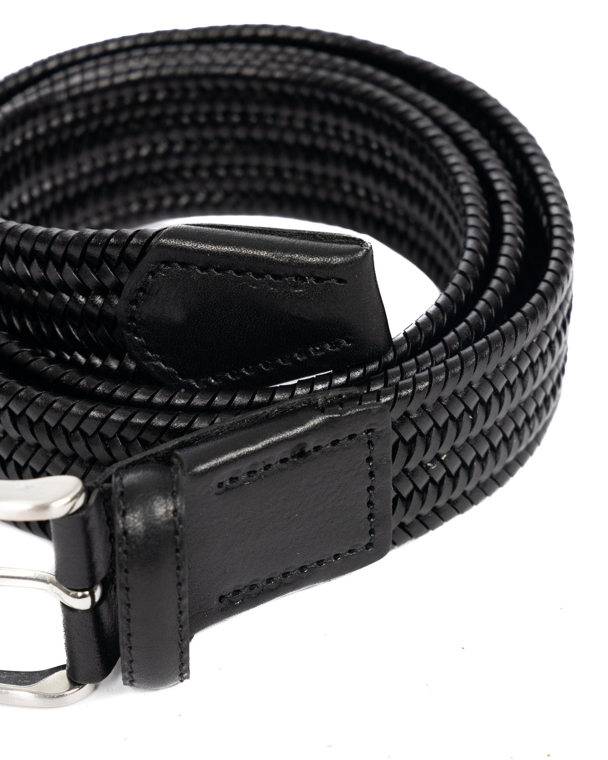 Black braided leather belt with silver buckle, coiled view showing woven texture and leather end tab detail.