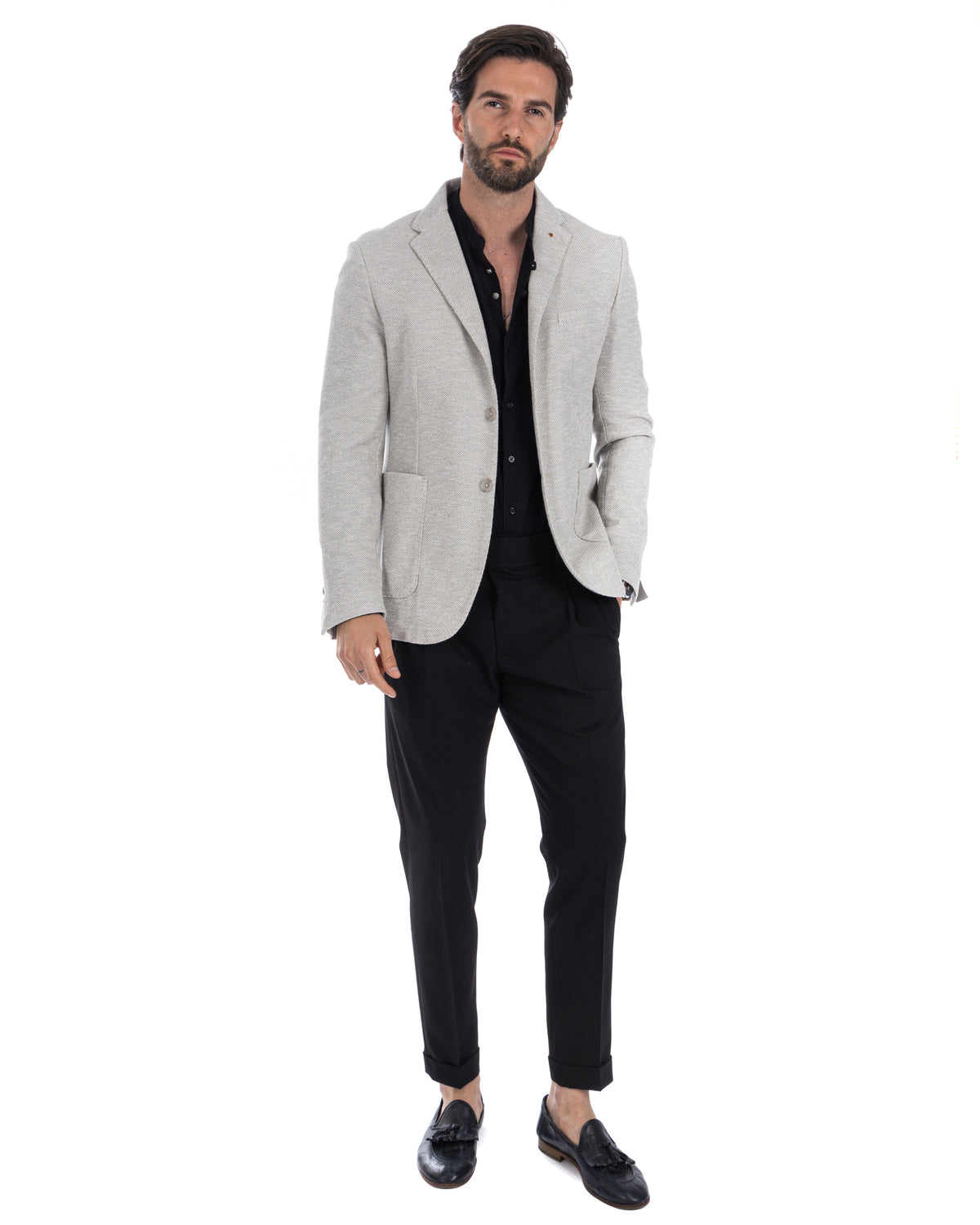 Men's light gray wool blend blazer with black shirt, slim black trousers, and tassel loafers. Smart casual business attire.