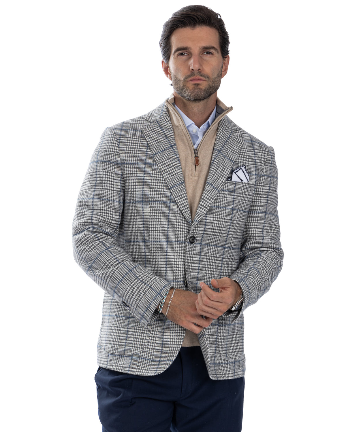 Men's grey plaid wool blazer with beige zip sweater, blue shirt, and navy trousers - smart casual layered look