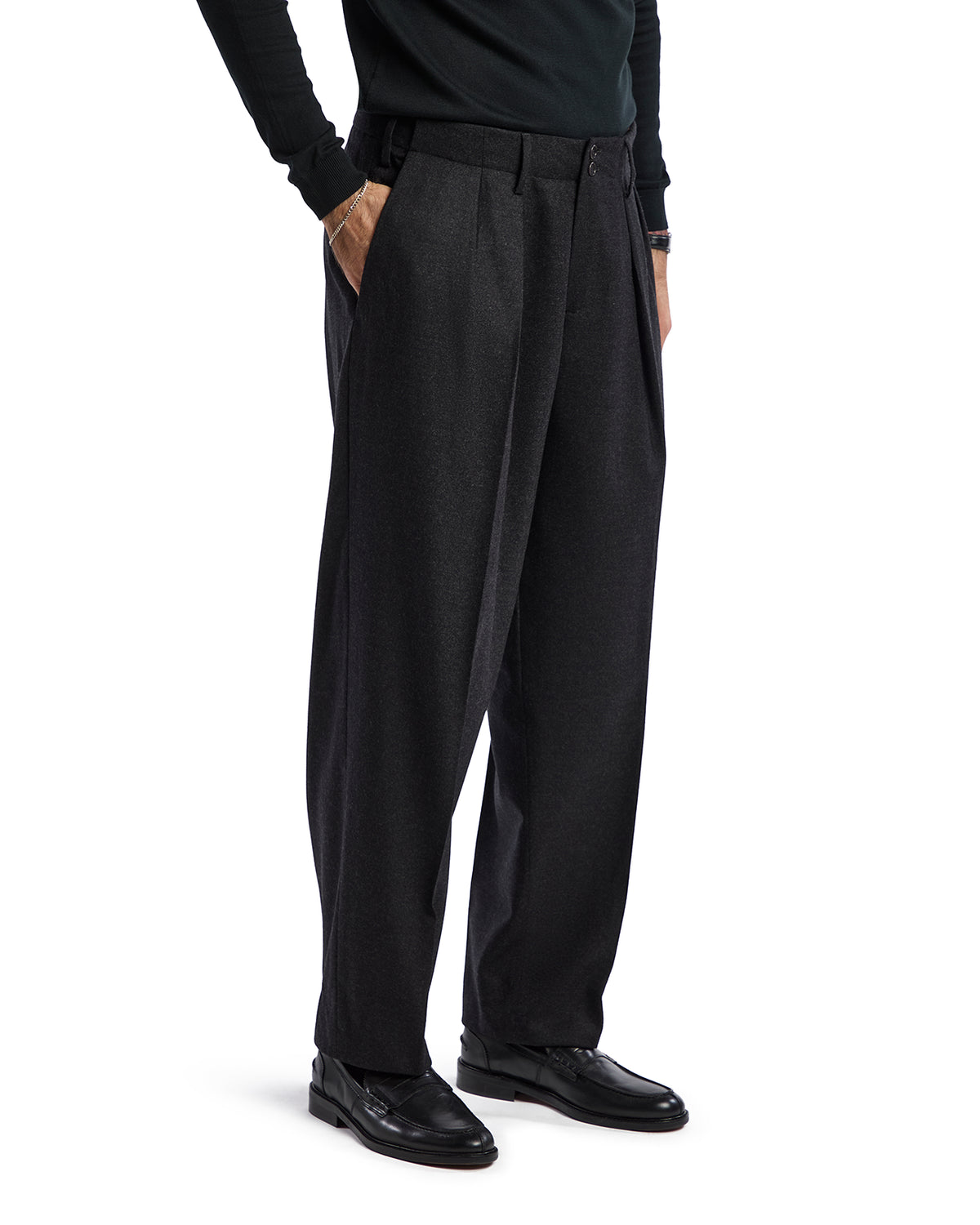 Men's charcoal gray pleated trousers, tailored fit, made from soft wool blend, styled for a sophisticated look.