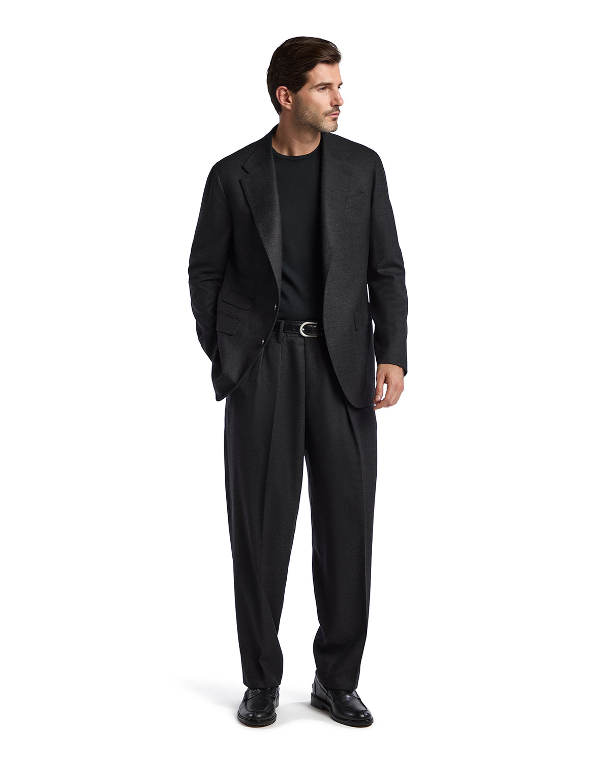 Men's black wool suit with a tailored blazer and pleated trousers, paired with a black crewneck sweater.