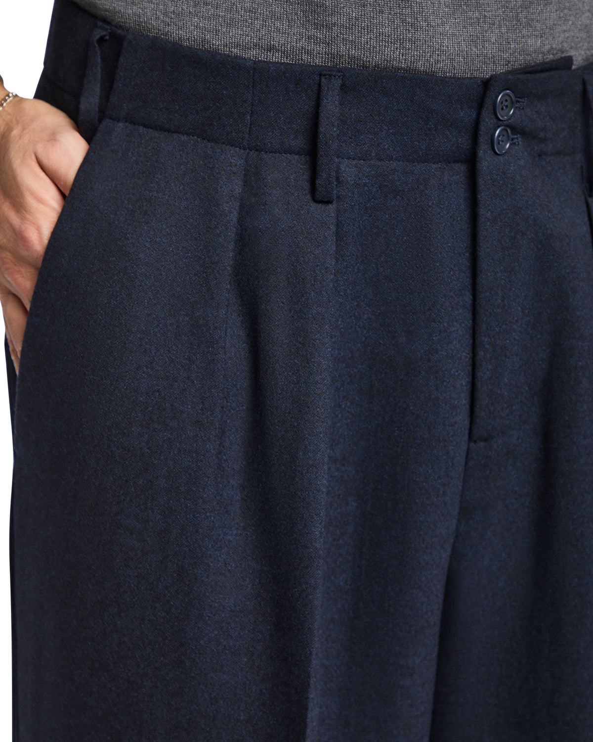 Navy blue wool blend tailored trousers with pleats and button closure for a sophisticated look.