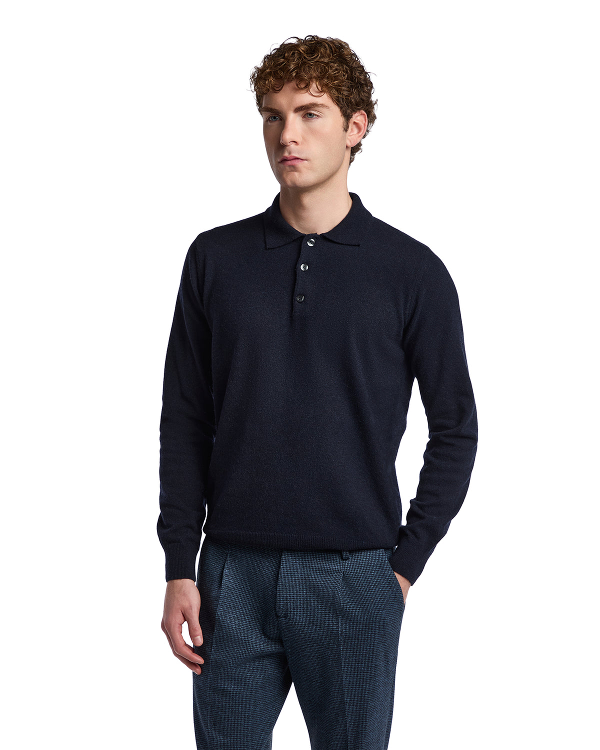 Navy wool polo shirt for men with long sleeves and buttoned placket, paired with tailored trousers.
