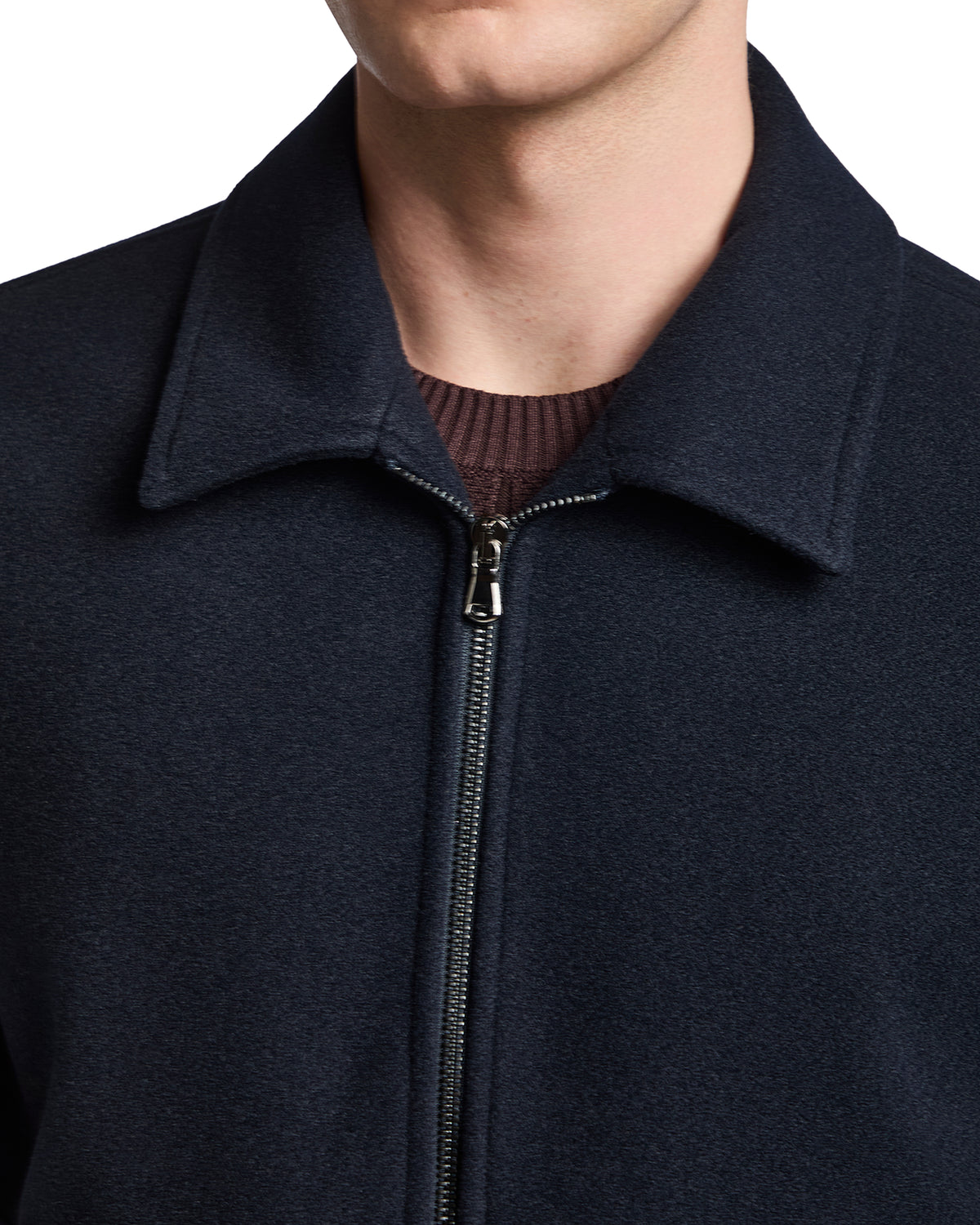 Navy blue wool blend zip-up jacket with a collared neck and textured fabric detail. ideal for stylish layering.