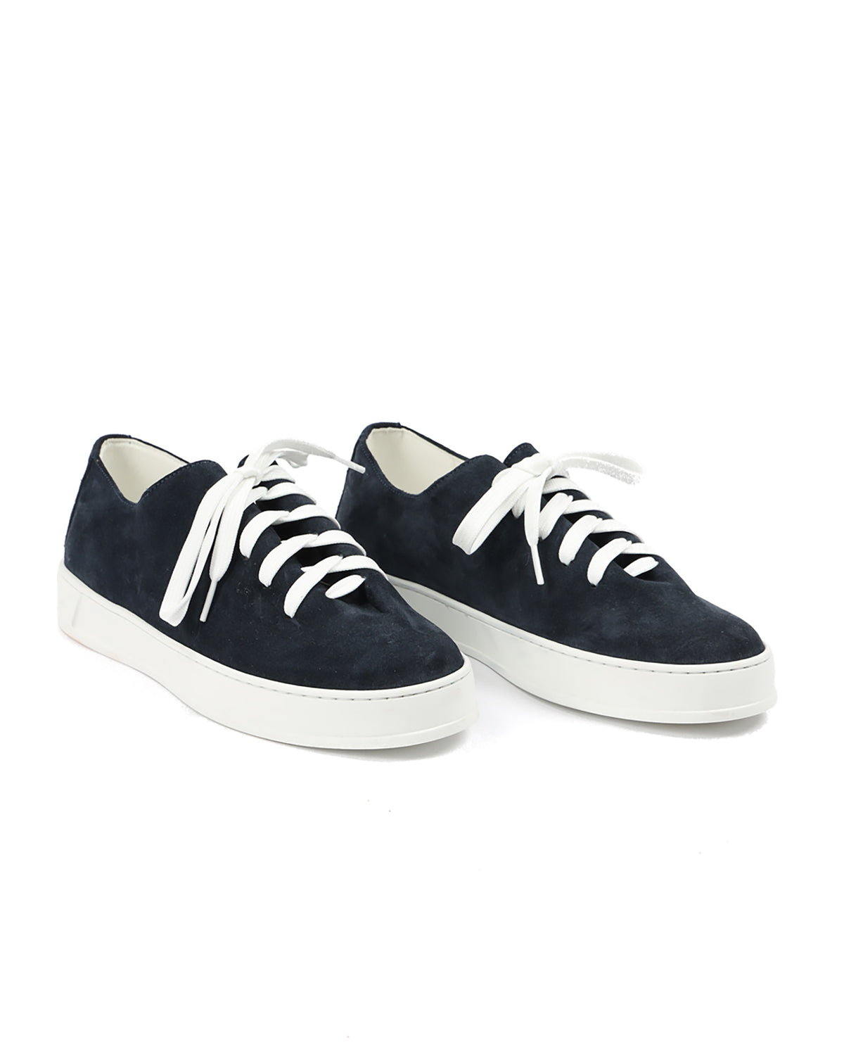 Navy suede sneakers with white laces and rubber soles, featuring a modern, minimalist design.