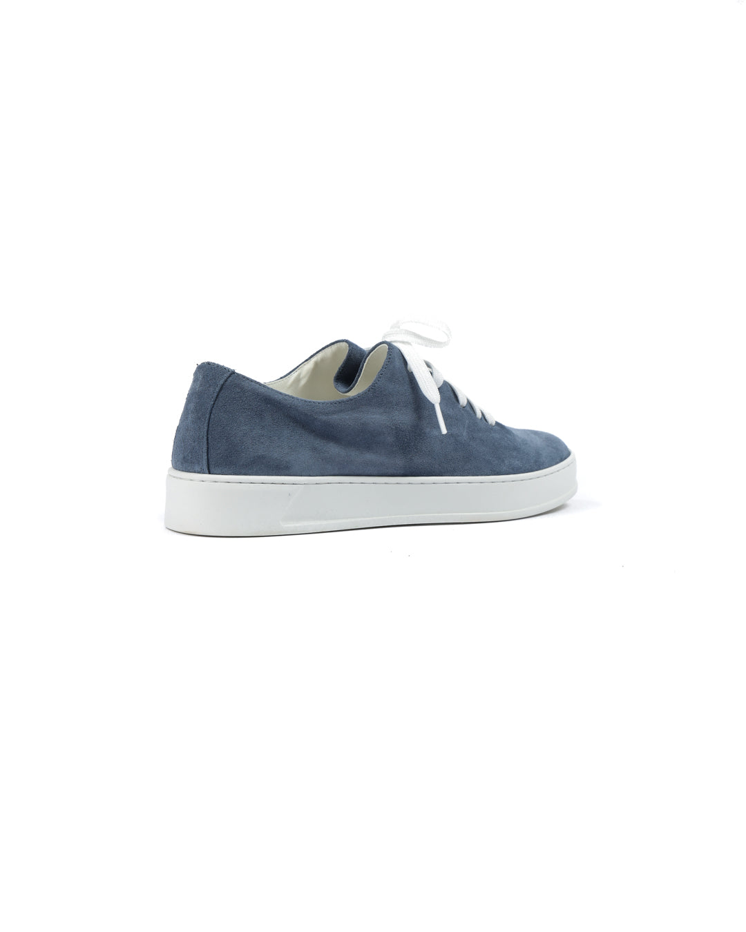 Blue suede low-top sneakers with white laces and a minimalist design, perfect for casual wear.