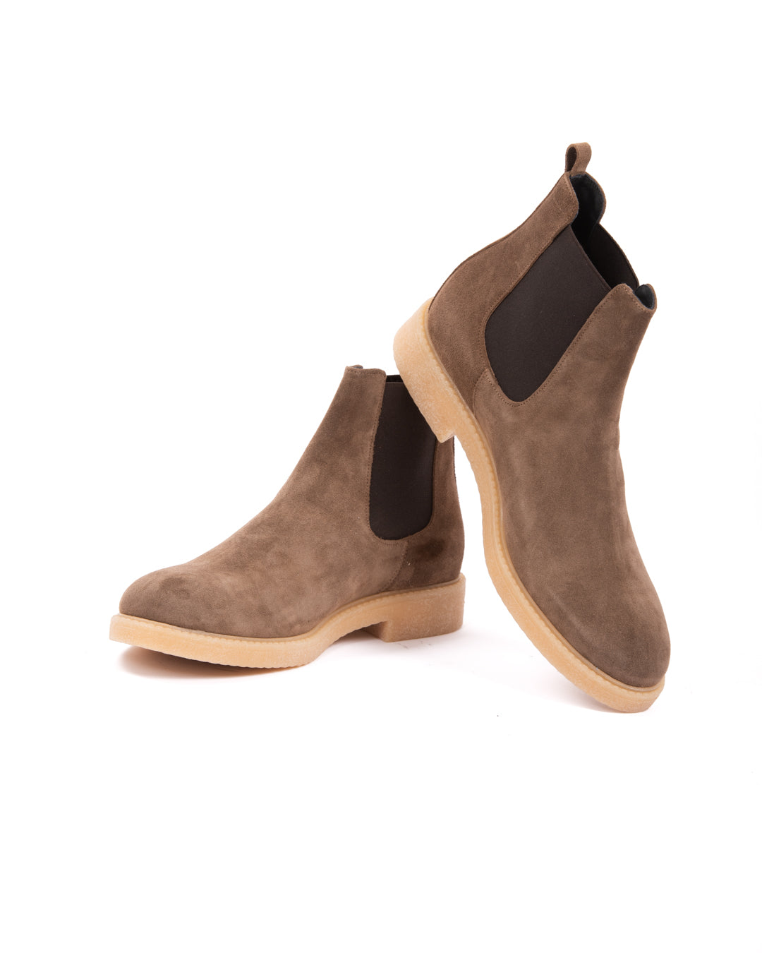 Brown suede Chelsea boots with black elastic side panels and light rubber soles. Stylish and versatile footwear.
