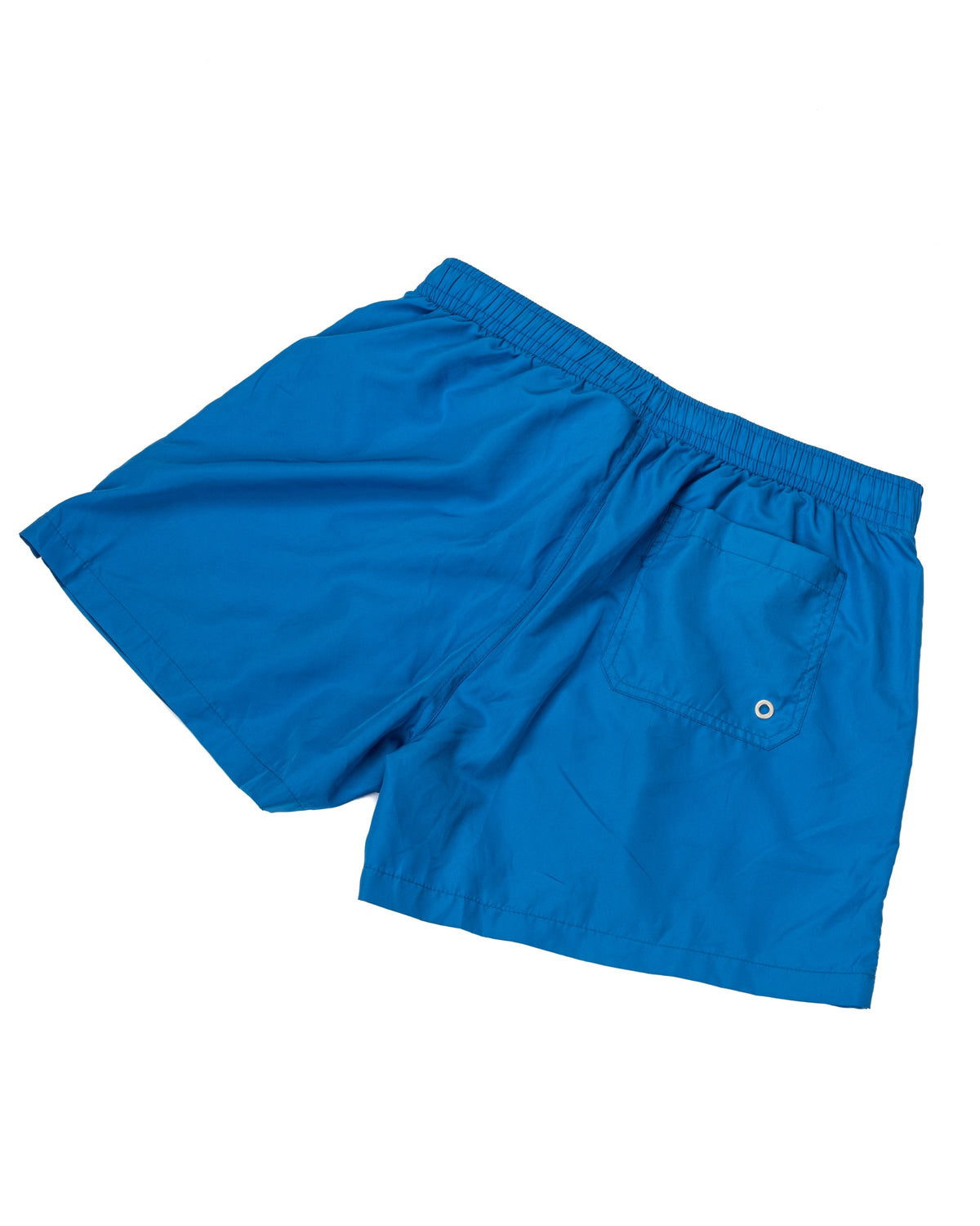 Bright blue swim shorts with elastic waist and back welt pocket, laid flat