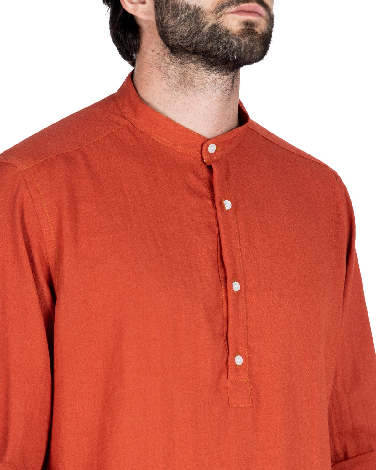 Close-up detail of a rust orange linen shirt's grandad collar and half-button placket