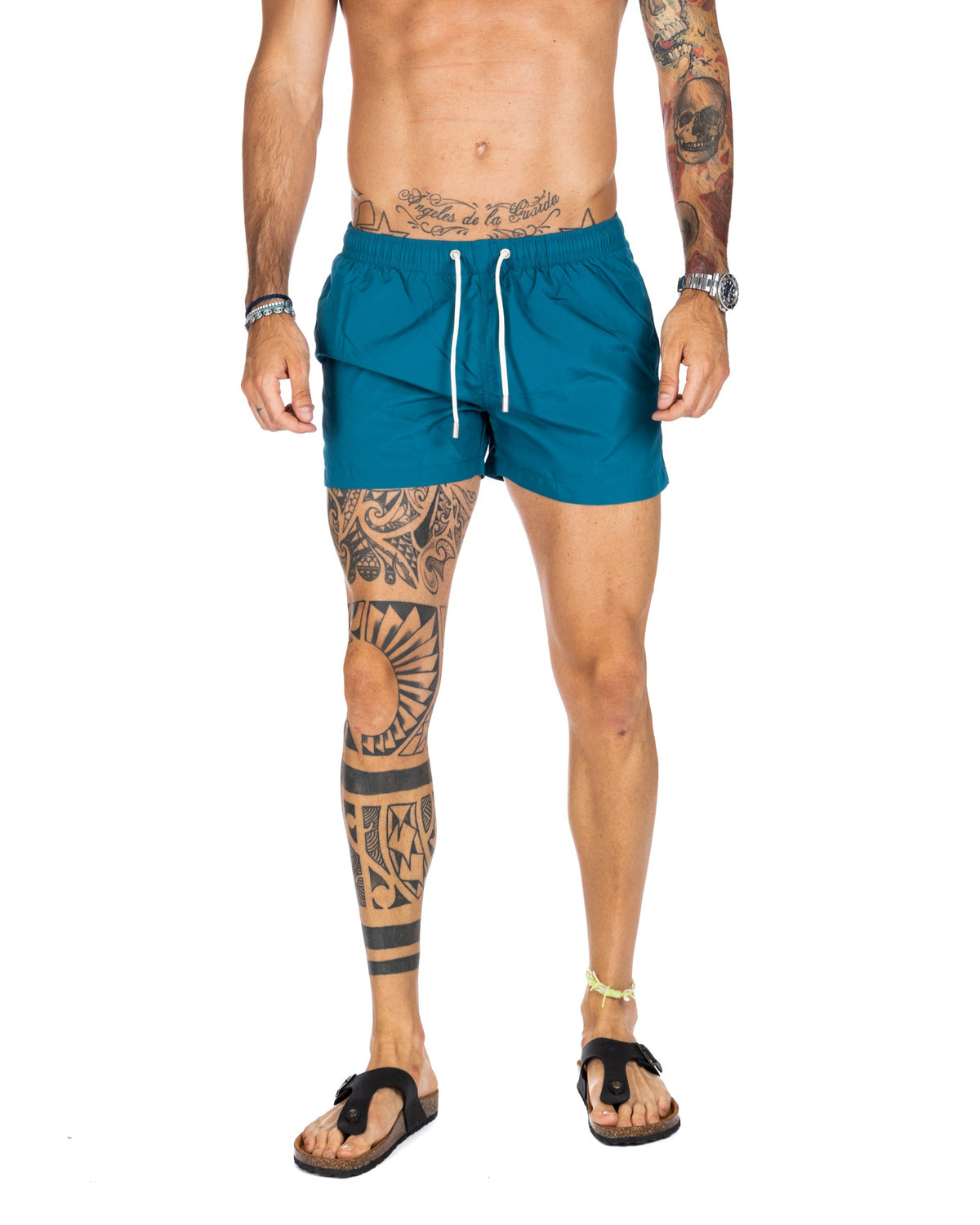Men's teal swim shorts with white drawstring, shown on a model from the front
