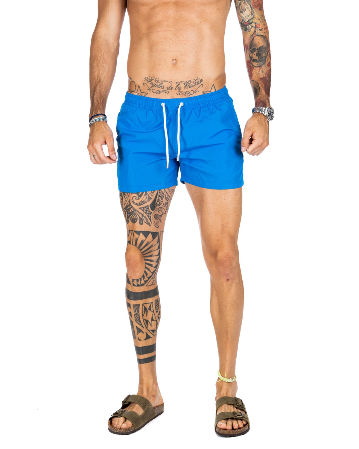 Men's bright blue swim shorts with white drawstring cord, shown on a model